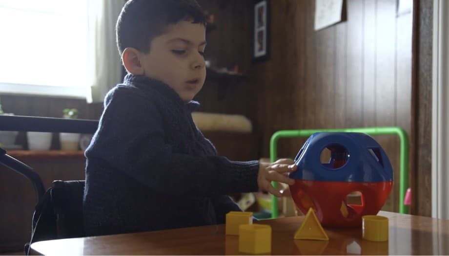 Video: a young boy plays with a sorter toy