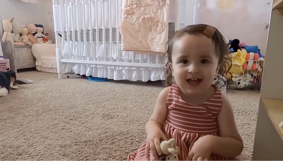 Video: a toddler girl plays in her bedroom
